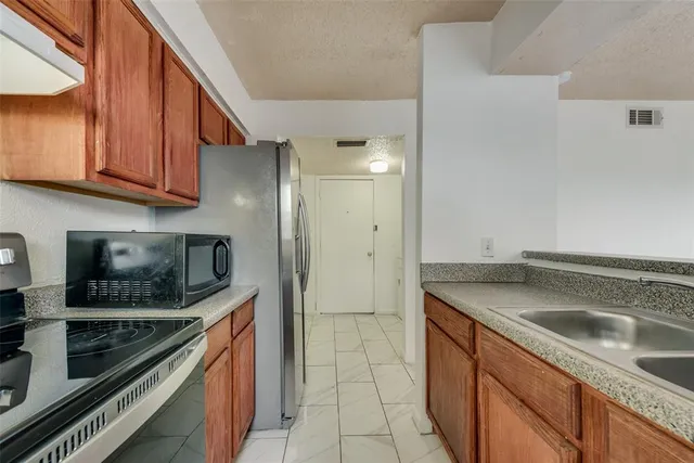 a kitchen with a sink stove and microwave