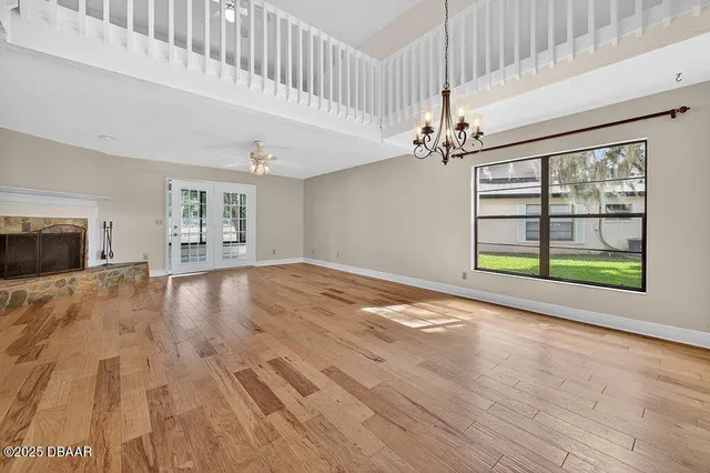 an aerial view of a house with a garden and lake view