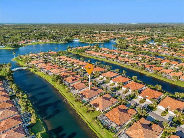 an aerial view of residential houses with outdoor space and river