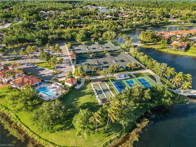 an aerial view of residential houses with outdoor space and swimming pool