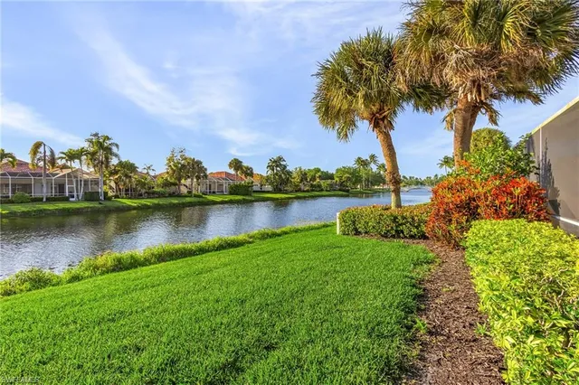 a view of a lake with houses in the back