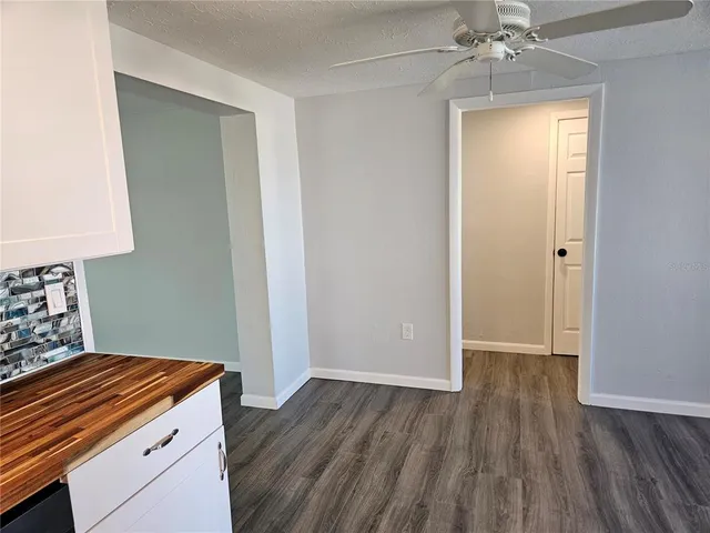 a kitchen with a wooden floor and a window