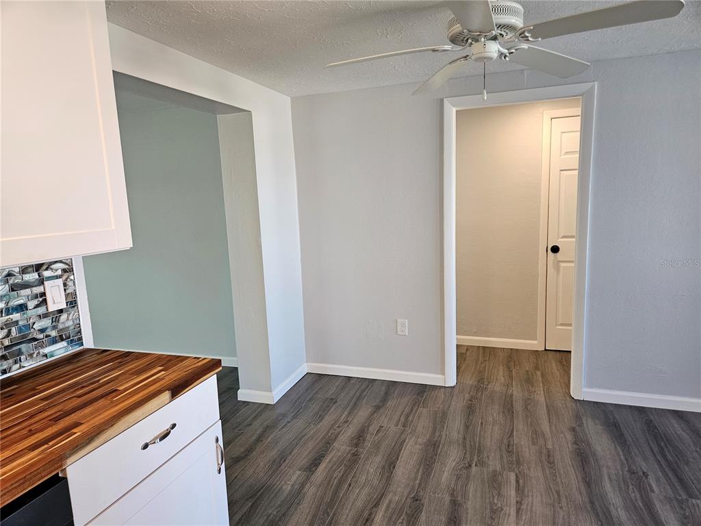 8229 Cypress Road Englewood, FL 34224 - Photo 14 of 44 a kitchen with a wooden floor and a window