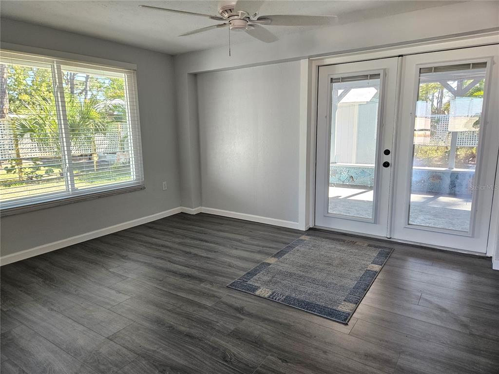 8229 Cypress Road Englewood, FL 34224 - Photo 18 of 44 a view of an empty room with wooden floor and a window