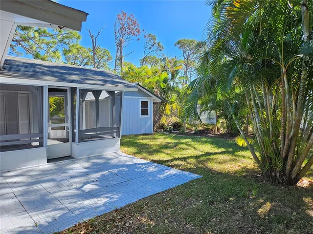 a view of a house with pool and sitting area