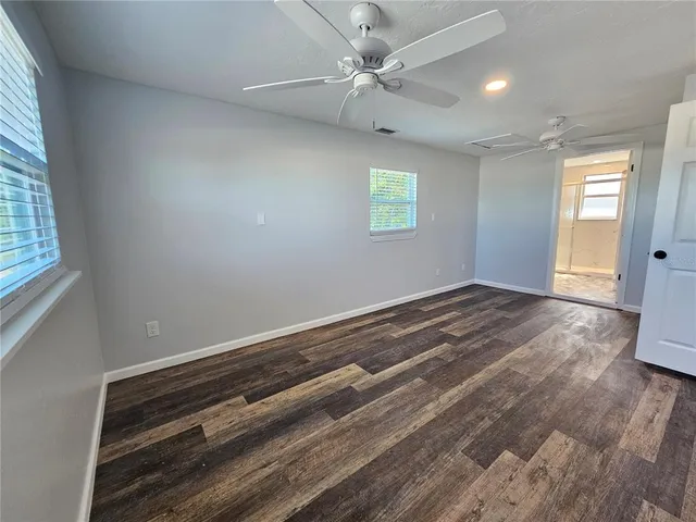 a view of hallway with wooden floor