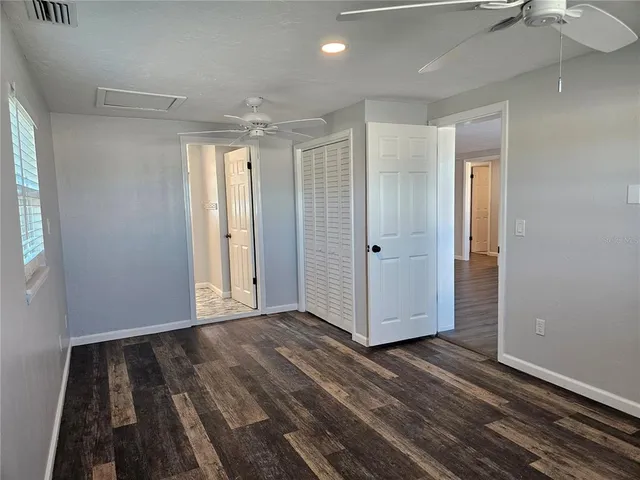 a spacious bathroom with a granite countertop sink toilet and shower