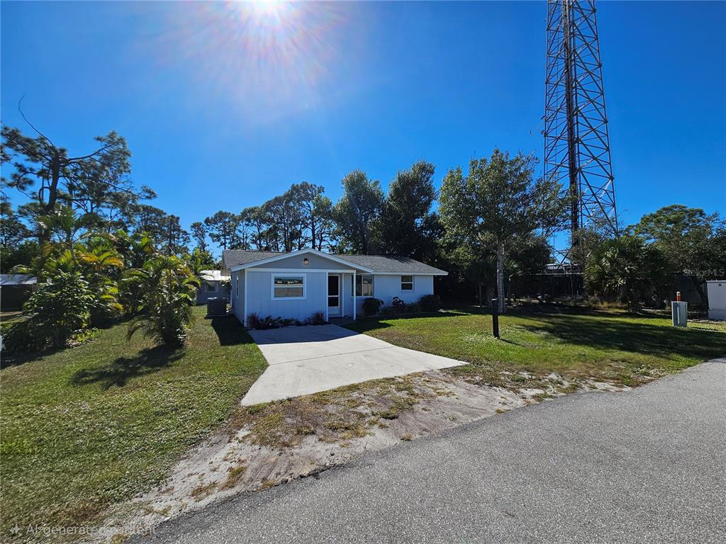 8229 Cypress Road Englewood, FL 34224 - Photo 44 of 44 a house that is sitting in the grass with large trees