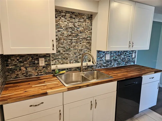 a kitchen with granite countertop a sink and a stove
