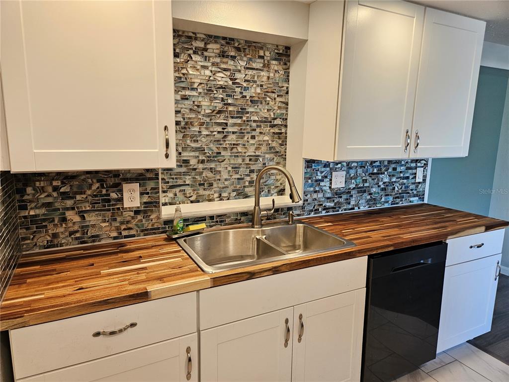 8229 Cypress Road Englewood, FL 34224 - Photo 10 of 44 a kitchen with granite countertop a sink and a stove