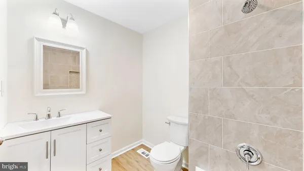 a bathroom with a sink a toilet and a mirror