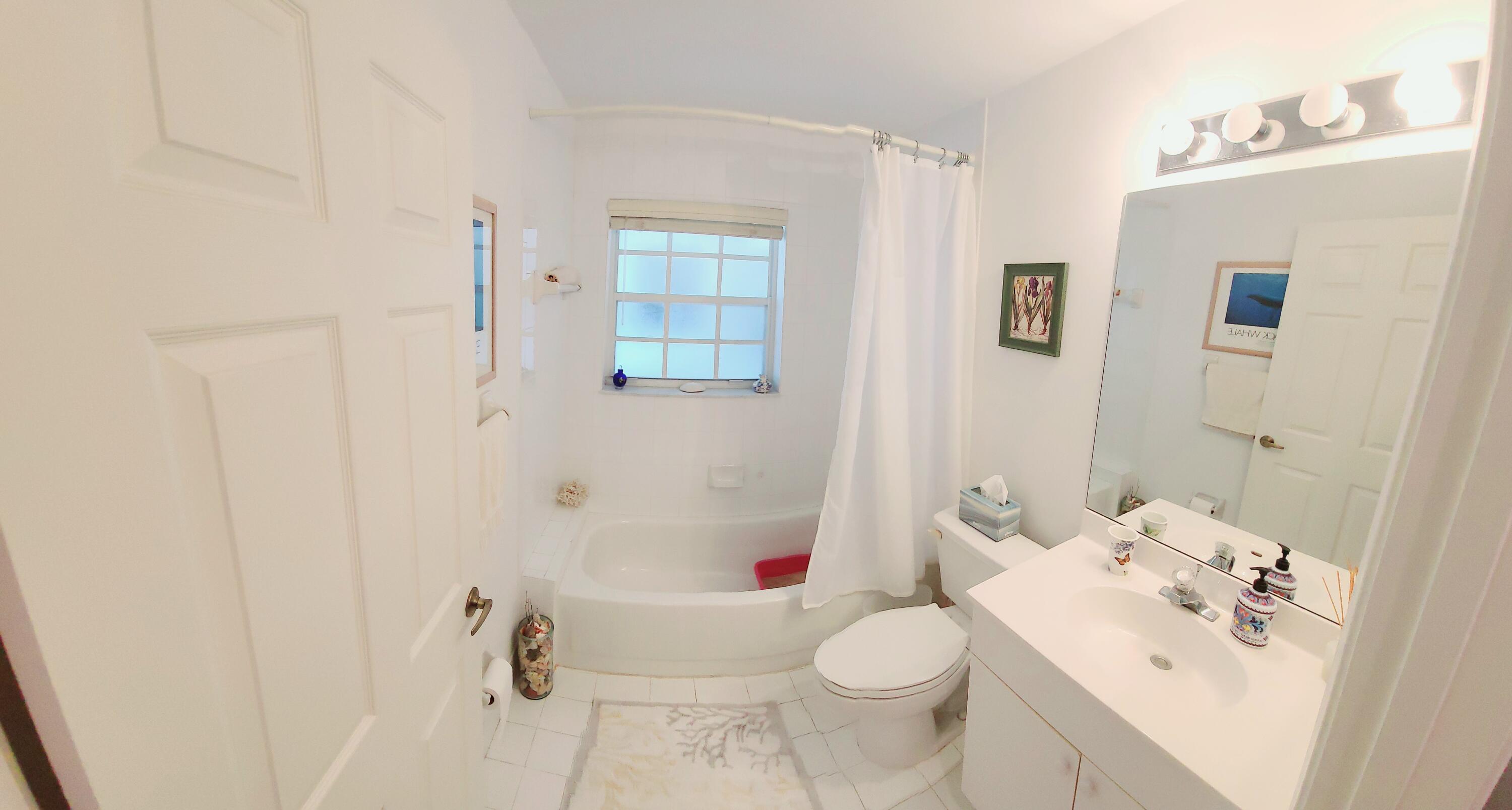 5121 Sabal Gardens Lane, Unit 2 Boca Raton, FL 33487 - Photo 21 of 25 a bathroom with a sink toilet and shower