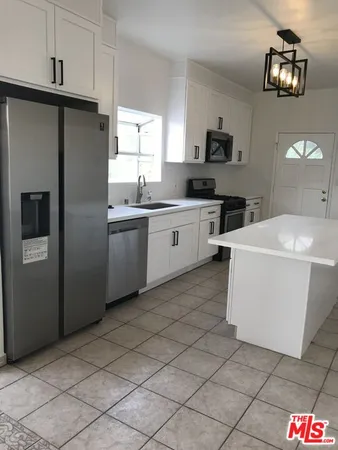 a kitchen with a sink and refrigerator