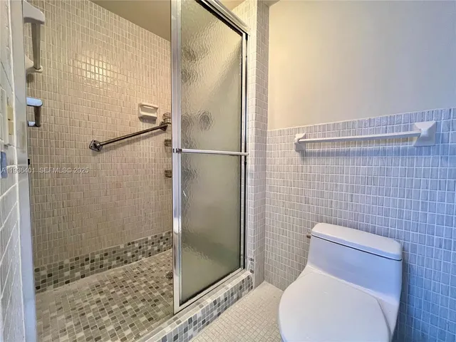 a bathroom with a toilet and shower