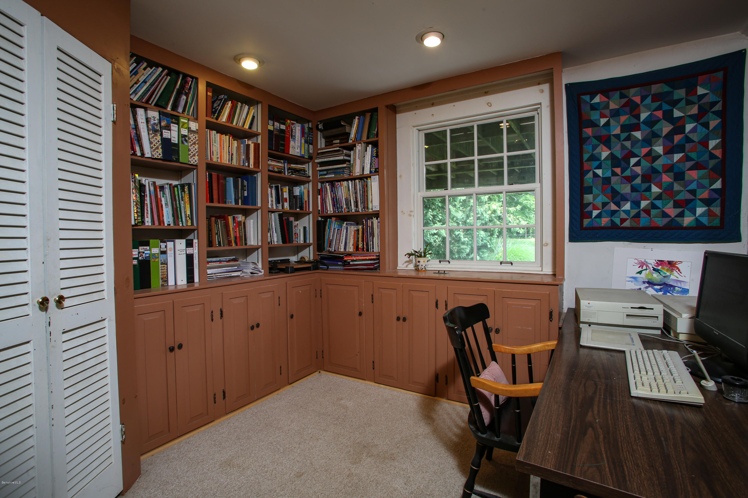 32 Old Post Road Worthington, MA 01098 - Photo 22 of 49 a view of a workspace with furniture and a bookshelf