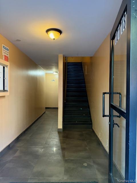 101-18 39th Avenue Queens, NY 11368 - Photo 7 of 13 a view of a hallway with wooden floor and stairs