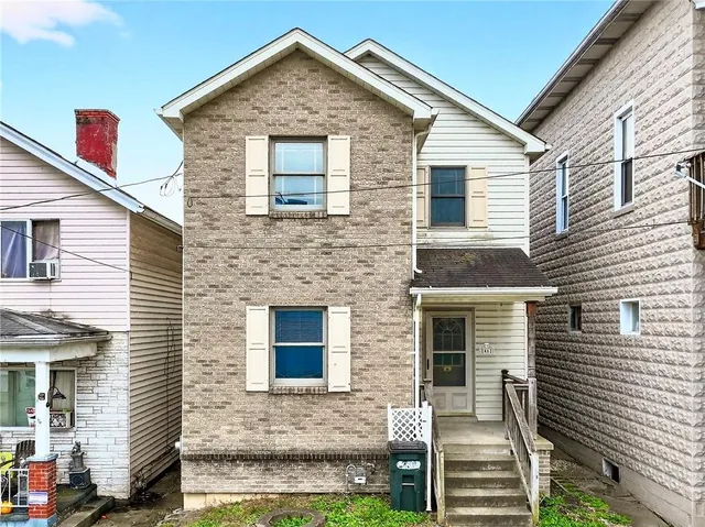 a front view of a house with garage