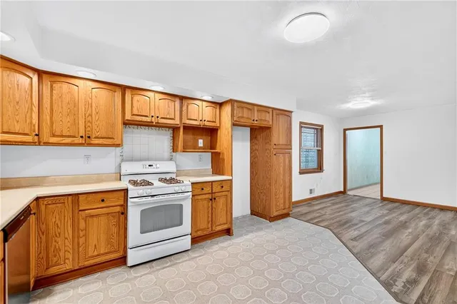 a kitchen with a stove top oven and refrigerator