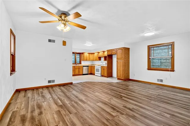 wooden floor in an empty room with a window