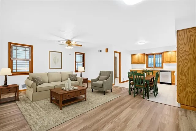 a living room with furniture and wooden floor