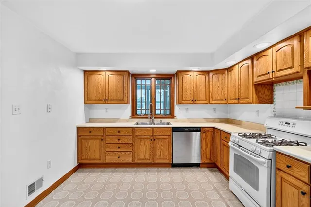 a kitchen with stainless steel appliances granite countertop a sink and cabinets