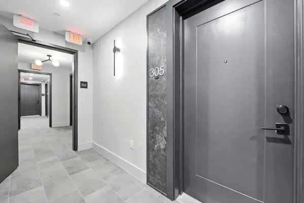 a view of a hallway with wooden floor