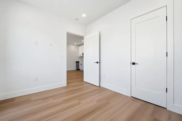 a view of a room with wooden floor