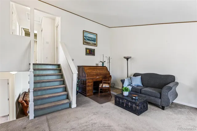 a living room with furniture and a ceiling fan