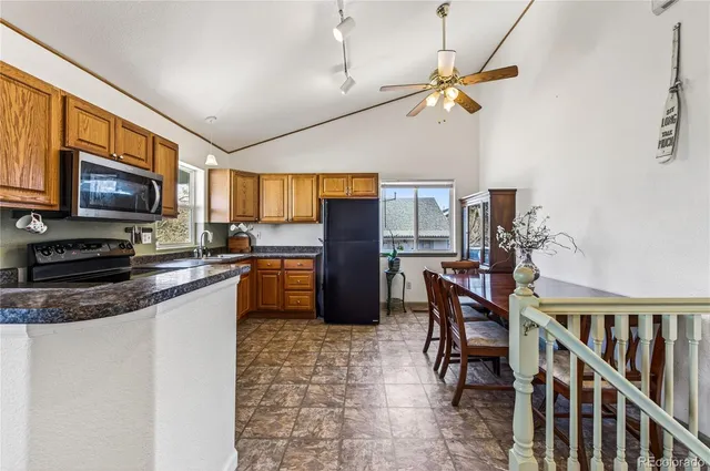 a kitchen with stainless steel appliances granite countertop a refrigerator stove microwave and sink