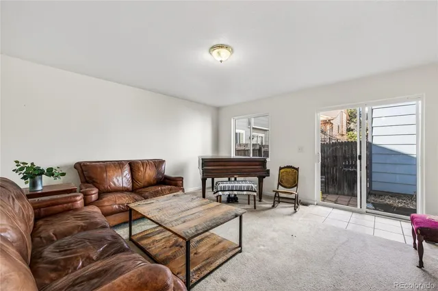 a living room with furniture and a book shelf