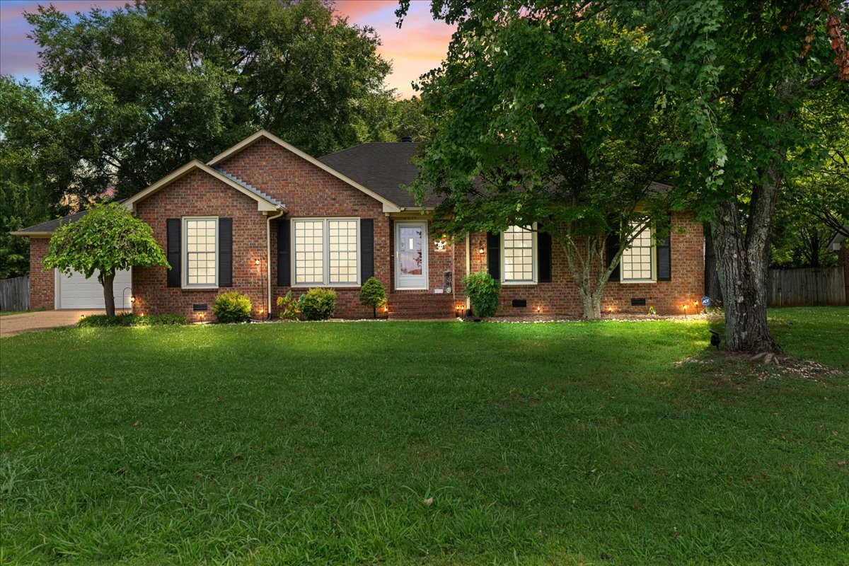 a front view of house with yard and green space