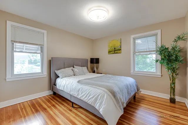 a bedroom with a bed and a lamp