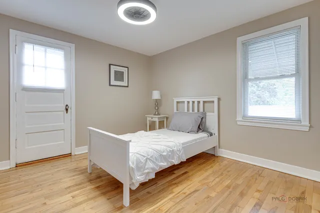 a bedroom with a bed and wooden floor