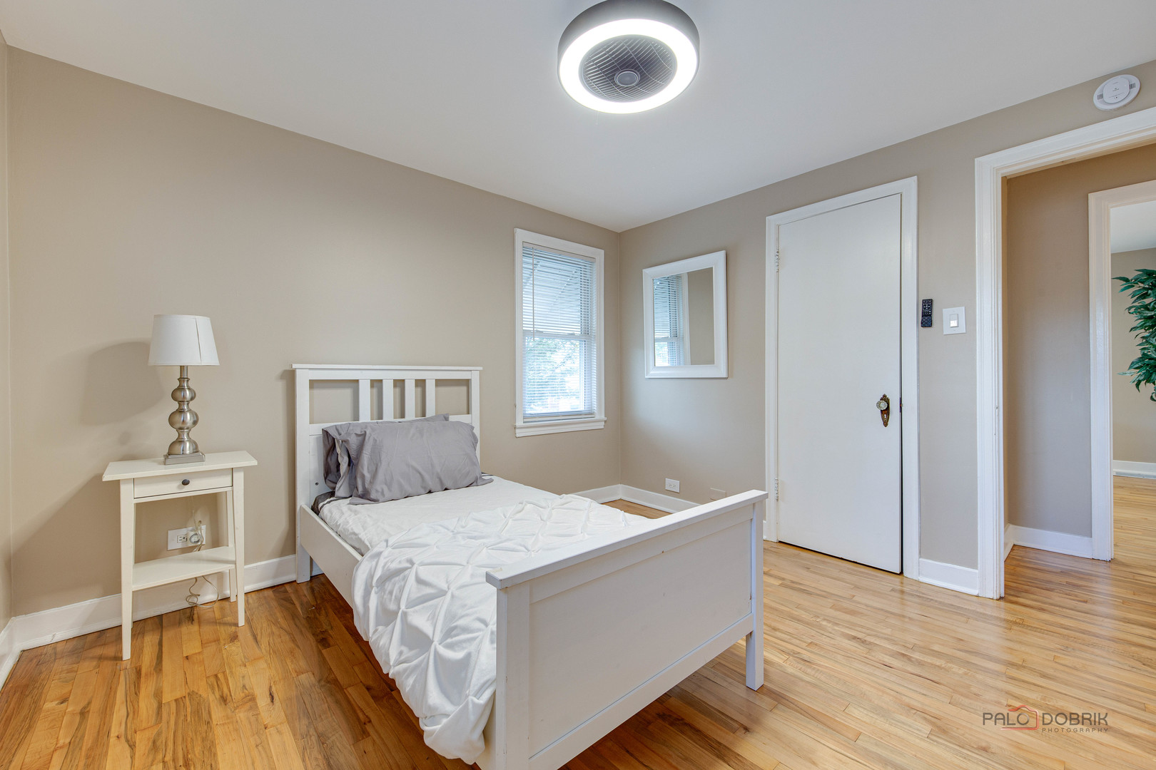 2320 South 22nd Avenue Broadview, IL 60155 - Photo 21 of 35 a bedroom with a bed and wooden floor