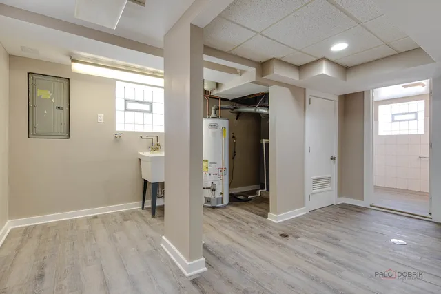 an empty room with wooden floor and entryway