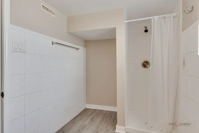 a bedroom with a bed and a potted plant