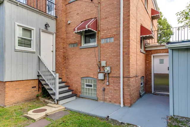 a pathway of a house with a yard