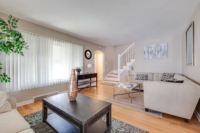 a living room with furniture and a potted plant