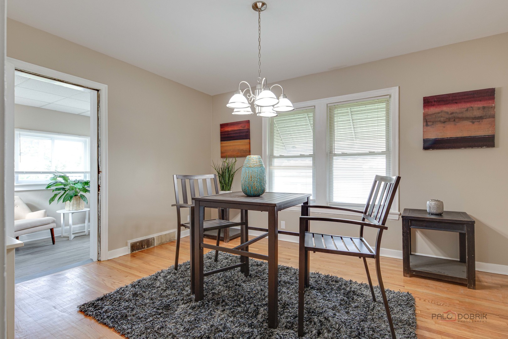 2320 South 22nd Avenue Broadview, IL 60155 - Photo 7 of 35 a dining room with furniture wooden floor a rug and a chandelier