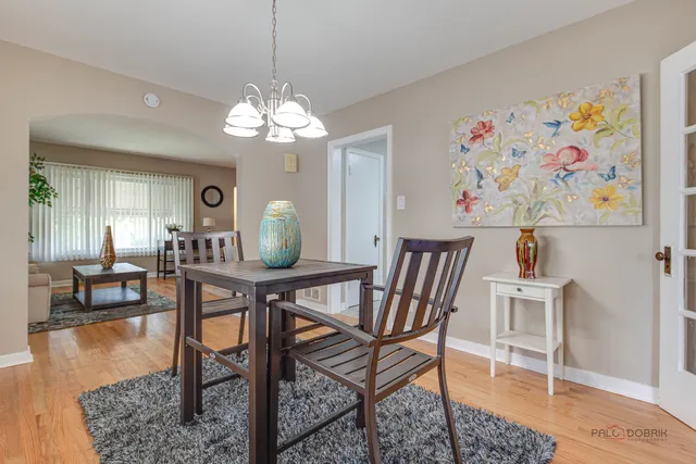 a view of a dining room with furniture wooden floor and a chandelier