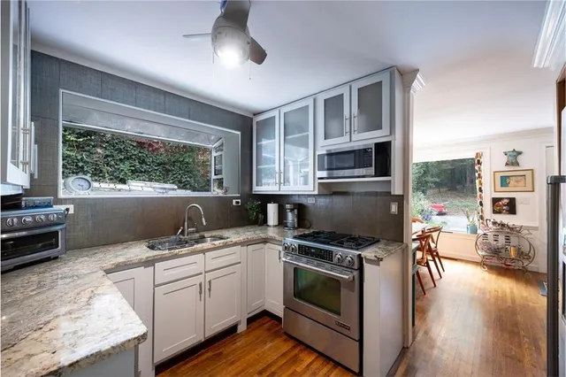 a kitchen with a stove a sink and a microwave