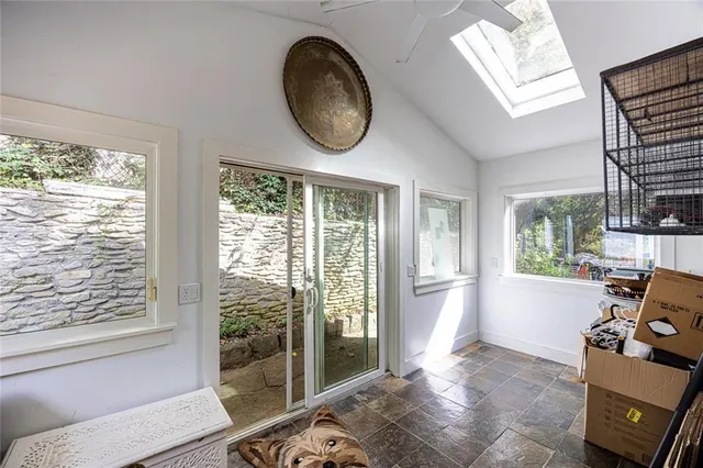 a view of a room that has a bed and a mirror in it