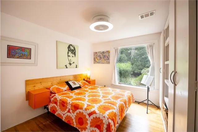 a bed sitting in a bedroom next to a window