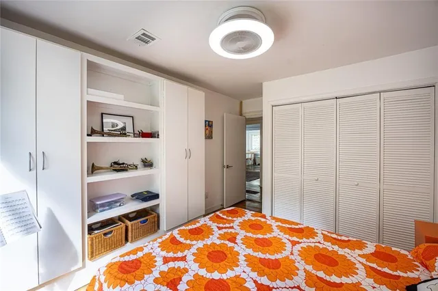 a bedroom with a bed and a closet