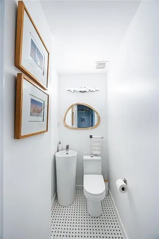 a bathroom with a toilet a sink and a mirror