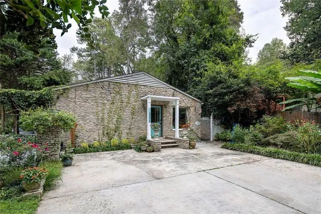 a front view of a house with garden