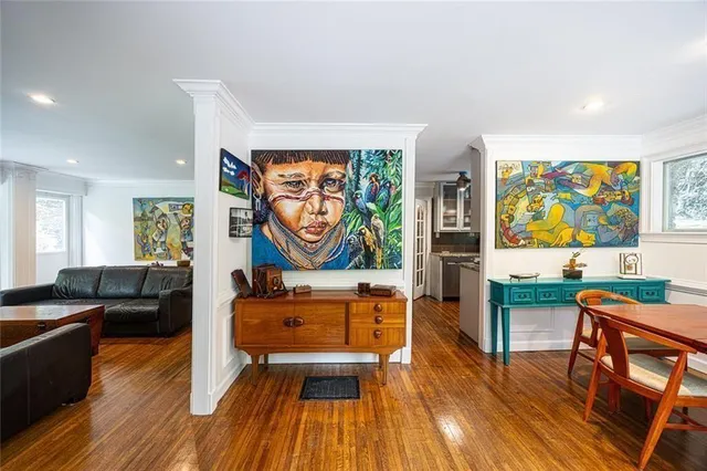 a living room with furniture and wooden floor
