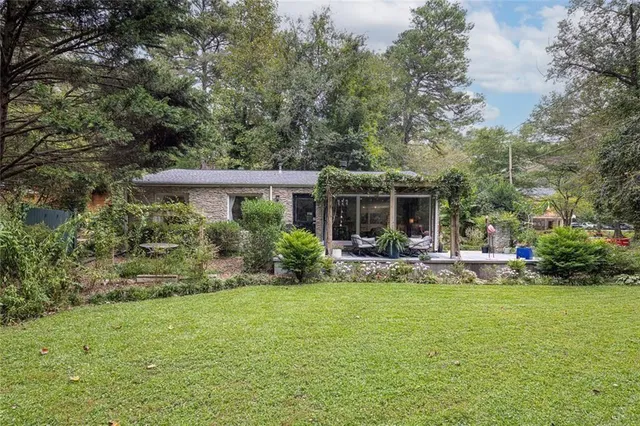 a front view of a house with swimming pool having outdoor seating