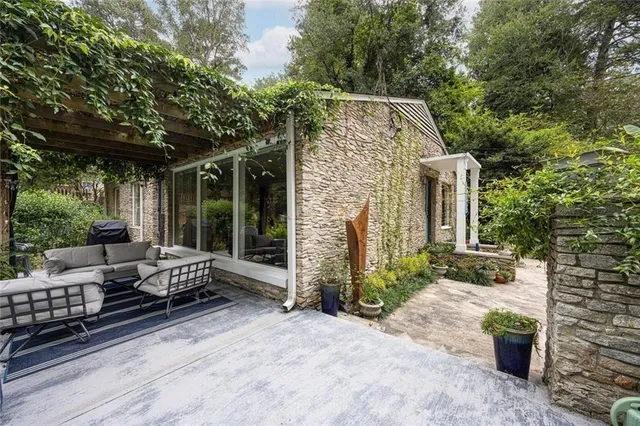 a view of house with backyard outdoor seating and green space