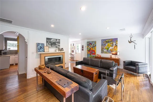 a living room with furniture a fireplace and a wooden floor